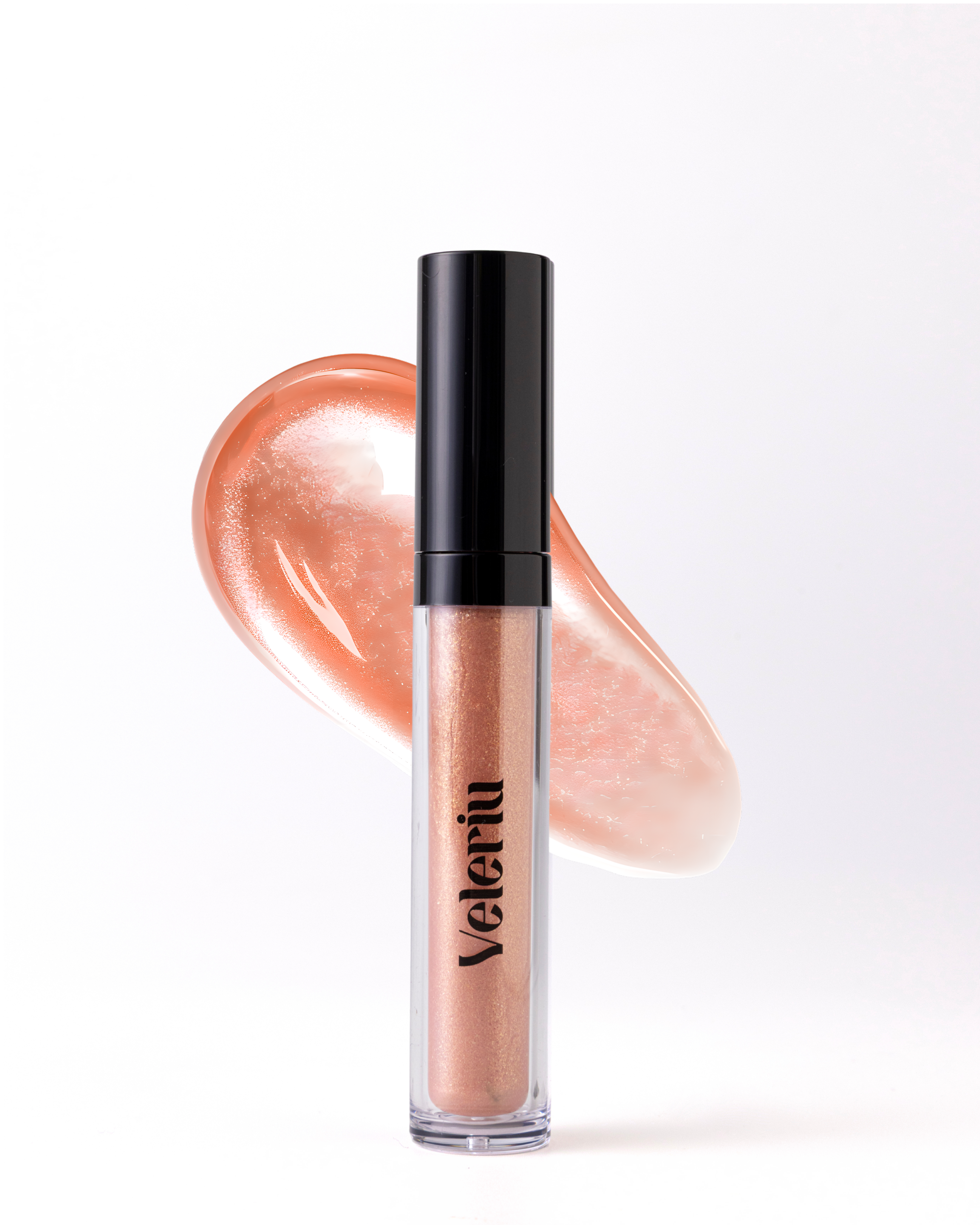 Whimsy translucent champagne nude gloss with neutral undertones, featuring shimmering particles for a fuller lip appearance.